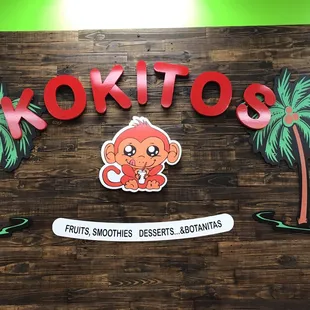 a sign with a monkey and palm trees