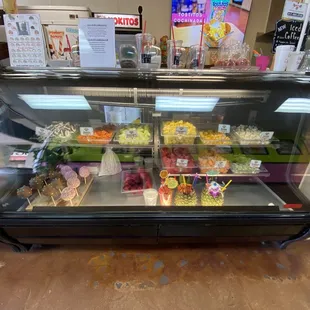 a display case with a variety of desserts