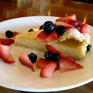 The Torta de la Nonna is a shining summer treat with soft sweet crust filled with pastry cream, topped with fresh berries.