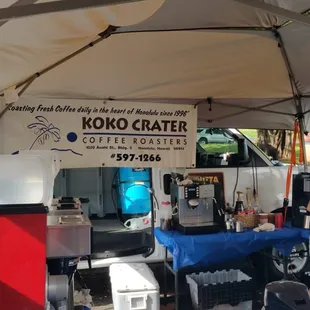 a woman standing under a tent