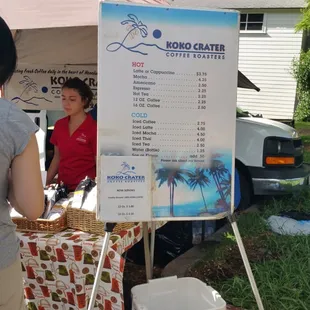 a woman standing in front of a sign