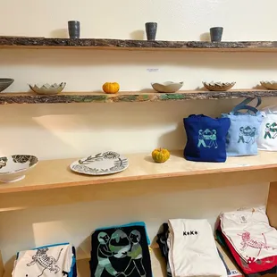 a variety of t - shirts on a shelf