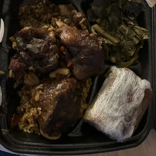 Oxtail meal with rice, greens and cornbread