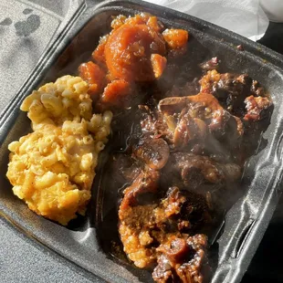 Plate with mac &amp; cheese, candied yams and oxtails