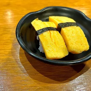 Tamago Sushi. Cool, firm, sweet egg sitting on a little patch of sushi rice. It was my first time trying this out and it was pretty good!