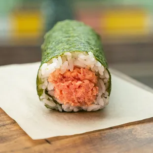 a sushi roll on a piece of paper