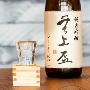 a glass of sake and a bottle of sake