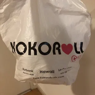 a hand holding a bag of food