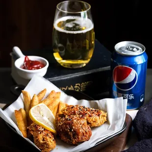 a glass of beer and a plate of fries