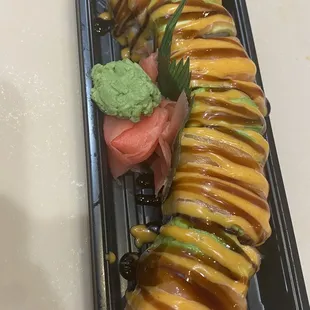 This godzila tempura tilapia rolled and put top avocado and salmon and special souce