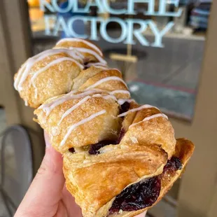 a hand holding a pastry