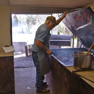 ows a man cooking in a kitchen