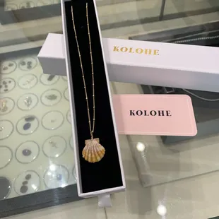 Custom 18k gold chain and one of a kind sunrise shell.