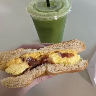 Green pressed juice, bacon egg and cheese bagel sandwich