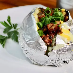 a baked potato wrapped in foil