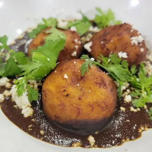 Molotes de platano. Plantain balls in mole.