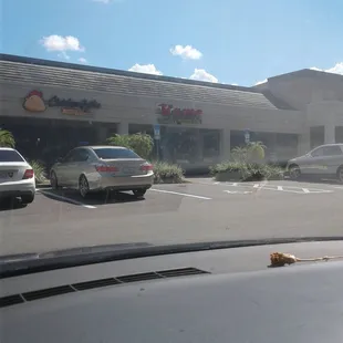 a parking lot with cars parked in front of it