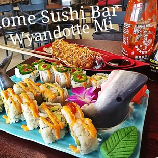a plate of sushi and a bottle of beer