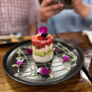 a person taking a picture of a plate of food