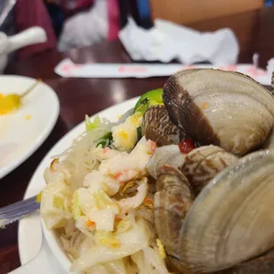 a plate of clams and a bowl of salad