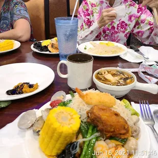a woman eating a meal with chopsticks