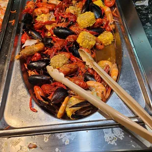 a variety of seafoods in a buffet