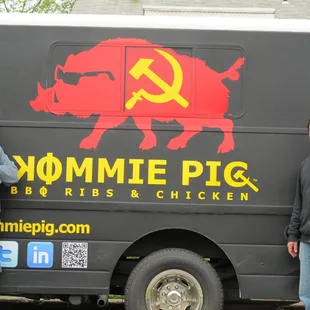 two men standing in front of a truck
