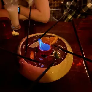 a bowl of fruity drink with a lit candle