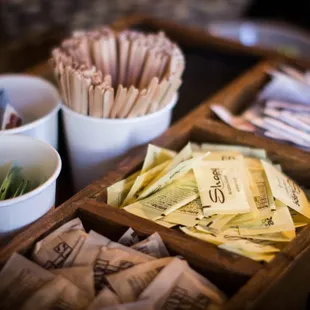 a variety of paper straws in a wooden box