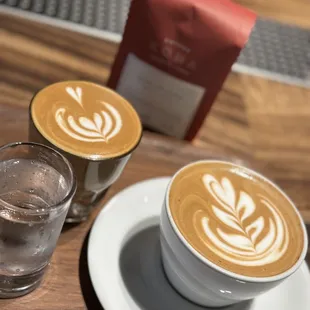 Cortado on the left and vanilla latte on the bottom right.