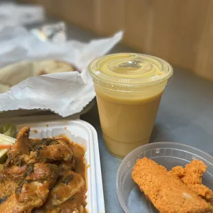 a meal of chicken, coleslaw, and a drink