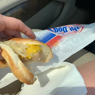 The kraut dog with mustard. Barely warm and the hot dog looks unappetizingly pale.