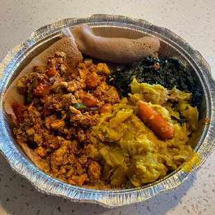 Chicken tibs with tikel gomen and gomen w/dinich (cabbage and spinach). Paired with the best spongy injera