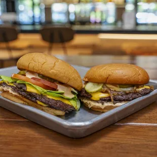 two burgers on a tray