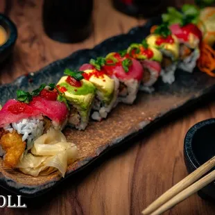 a sushi roll on a plate with chopsticks
