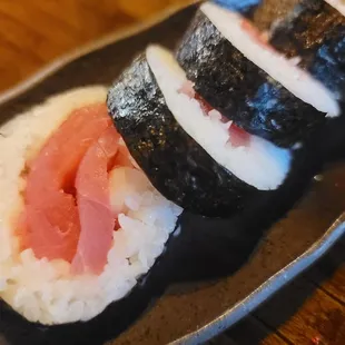three pieces of sushi on a plate