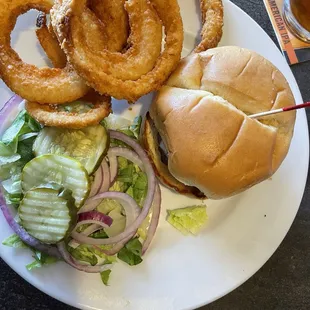 Bison burger with onion rings.