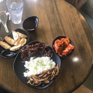 Beef Bulgogi with rice, A side of kimchi, and some deep fried wontons.