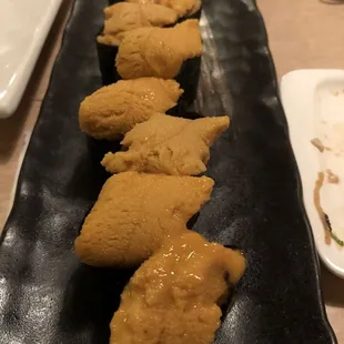 a plate of fried chicken on a black plate