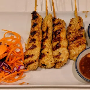 chicken skewers on a white plate