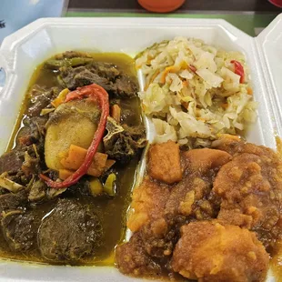 Curry goat with two sides. Cabbage and sweet yam