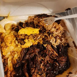 Large Brown Stewed Chicken with Mac &amp; cheese rice &amp; peas.