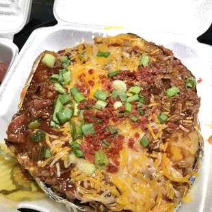a pizza in a styrofoam container