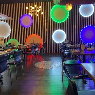 a brightly lit restaurant with tables and chairs