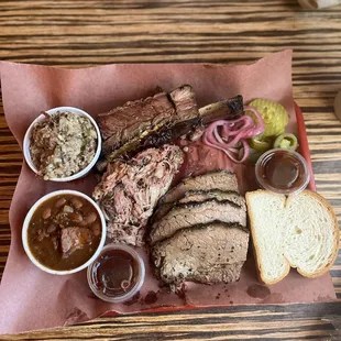 3 meat plate with 2 sides. Fatty brisket, pulled pork, beef rib. Beans and dirty rice.