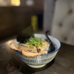 a bowl of ramen with chopsticks