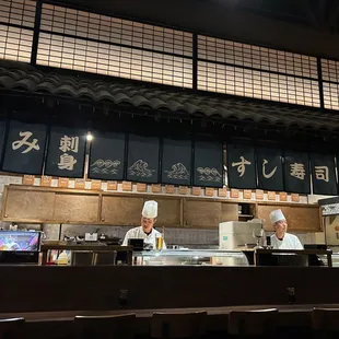 the chef's behind the sushi bar