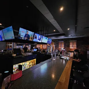 a bar with multiple televisions