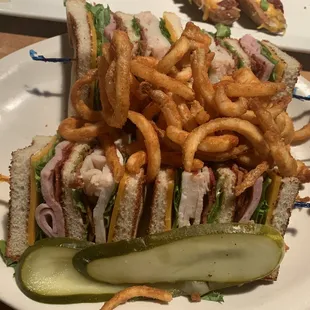 Turkey club sandwich w curly fries n sliced thin pickles