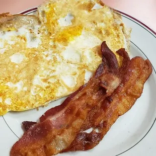 Thin bacon and eggs fried hard